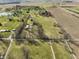 Aerial shot showcasing the property's verdant fields and nearby residential areas with mature trees at 11686 S 825 W, Edinburgh, IN 46124