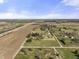 This aerial view displays a peaceful property with green fields, serene pond, and accessible highway at 11686 S 825 W, Edinburgh, IN 46124
