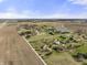 Aerial view showcasing a rural property with lush green spaces, a pond, and a charming home at 11686 S 825 W, Edinburgh, IN 46124