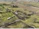 Aerial view displaying a well-maintained property with a long driveway and mature trees at 11686 S 825 W, Edinburgh, IN 46124