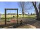 Swing set in the large backyard of property with mature trees and blue skies at 11686 S 825 W, Edinburgh, IN 46124