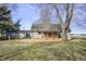 Backyard featuring a cozy, covered porch with an orange railing and an expansive lawn at 11686 S 825 W, Edinburgh, IN 46124