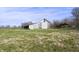 Exterior view of the barn on the property with a grassy field in the foreground and a blue sky overhead at 11686 S 825 W, Edinburgh, IN 46124
