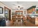 Bright dining room with a large wooden table, ceiling fan, and view to the exterior through sliding glass doors at 11686 S 825 W, Edinburgh, IN 46124