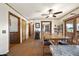 Open dining room with wood floors, decorative fireplace, ceiling fan, and sliding glass doors to outdoor space at 11686 S 825 W, Edinburgh, IN 46124