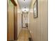 Hallway with wood paneling and neutral flooring, with doors leading to other rooms at 11686 S 825 W, Edinburgh, IN 46124