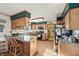 Traditional kitchen with wooden cabinets, eat-in bar, laminate countertops, and black appliances at 11686 S 825 W, Edinburgh, IN 46124