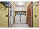 Laundry room with washer, dryer, overhead cabinets, and white tile floors at 11686 S 825 W, Edinburgh, IN 46124