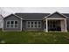 A well-manicured backyard featuring a covered patio with an outdoor fireplace at 1274 Clairet, Westfield, IN 46074