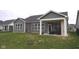 Spacious backyard featuring a covered patio with fireplace and well-maintained lawn at 1274 Clairet, Westfield, IN 46074
