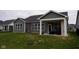 Expansive backyard featuring a covered patio with an outdoor fireplace, offering a cozy outdoor living space at 1274 Clairet, Westfield, IN 46074