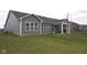 Large backyard showing the home's gray siding and covered outdoor living space at 1274 Clairet, Westfield, IN 46074