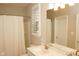 Bright bathroom featuring a shower/tub combo, white vanity, and plantation shutters for natural light at 1274 Clairet, Westfield, IN 46074