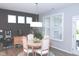 Bright dining room with a round table, seating for four, and natural light from large windows at 1274 Clairet, Westfield, IN 46074