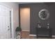 Stylish entryway with a white door, dark accent wall, modern mirror, and decorative console table at 1274 Clairet, Westfield, IN 46074