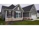 Side angle of a beautiful home showcasing gray siding, white trim, and a well-maintained lawn at 1274 Clairet, Westfield, IN 46074