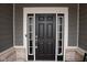 Elegant black front door with sidelights, adding a touch of sophistication to the home's exterior at 1274 Clairet, Westfield, IN 46074