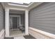 Covered front porch with gray siding, white trim, and a cozy seating area at 1274 Clairet, Westfield, IN 46074