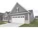 Attached, two-car garage with white door and gray exterior, adjacent to the main house at 1274 Clairet, Westfield, IN 46074