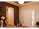 An entryway with white trim, a brown accent wall, and two lanterns at 1274 Clairet, Westfield, IN 46074