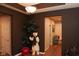 A hallway with dark brown walls and a view into another hallway. A light fixture hangs from the ceiling at 1274 Clairet, Westfield, IN 46074