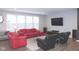 Cozy living room with hardwood floors, a red sofa set, and a large flat screen television at 1274 Clairet, Westfield, IN 46074