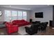 A living room with red and black leather sofas, a TV, and large windows with white shutters at 1274 Clairet, Westfield, IN 46074