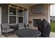 A covered patio featuring comfortable seating and an outdoor fireplace for relaxation and entertainment at 1274 Clairet, Westfield, IN 46074