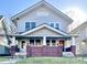 Traditional two-story home featuring a symmetrical facade with a covered porch and brick support columns at 1425 N Lasalle St, Indianapolis, IN 46201