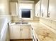 Functional kitchen with ample cabinet space and a window above the sink at 1425 N Lasalle St, Indianapolis, IN 46201