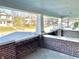 Spacious front porch featuring brick accents, offering a relaxing outdoor seating area at 1425 N Lasalle St, Indianapolis, IN 46201