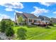 Beautiful landscaped backyard with mature trees, plants, and well manicured lawn at 1684 Beach St, Greenwood, IN 46143