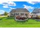 Well-maintained backyard with a lush lawn, landscaping, and a spacious deck, perfect for outdoor entertaining at 1684 Beach St, Greenwood, IN 46143