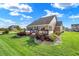 Spacious backyard featuring lush green grass, a patio area, and lovely landscaping, ideal for relaxation at 1684 Beach St, Greenwood, IN 46143