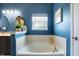 Relaxing bathroom featuring a soaking tub, oval mirrors and charming decor at 1684 Beach St, Greenwood, IN 46143