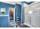Chic bathroom featuring a glass-enclosed shower, blue walls, and a walk-in closet at 1684 Beach St, Greenwood, IN 46143