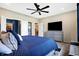 Well-lit bedroom featuring a comfortable bed and gray dresser with a TV and closet at 1684 Beach St, Greenwood, IN 46143