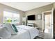 Comfortable bedroom with a TV, mirror, neutral walls and an abundance of natural light at 1684 Beach St, Greenwood, IN 46143