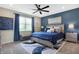 Comfortable bedroom with a ceiling fan, large window, and stylish blue accent wall at 1684 Beach St, Greenwood, IN 46143