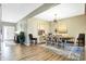 An open-concept dining area with modern light fixture, wood floors and room for seating at 1684 Beach St, Greenwood, IN 46143