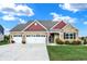 Charming brick home with a three-car garage, manicured lawn, and beautiful landscaping at 1684 Beach St, Greenwood, IN 46143