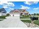 Inviting home with a three-car garage, landscaping, and a well-maintained lawn at 1684 Beach St, Greenwood, IN 46143