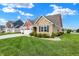 Beautiful home with a manicured lawn, flower beds, and a three-car garage at 1684 Beach St, Greenwood, IN 46143