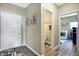 Hallway with doors to a powder room and laundry room and a white door to another part of the house at 1684 Beach St, Greenwood, IN 46143