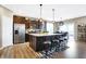 Well-equipped kitchen with stainless steel appliances, center island, barstools, and a dining area at 1684 Beach St, Greenwood, IN 46143