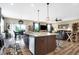 Open-concept design with kitchen island bar seating, wood cabinets and modern appliances at 1684 Beach St, Greenwood, IN 46143