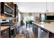 This kitchen features stainless appliances, wood cabinets, and a dining table for casual dining at 1684 Beach St, Greenwood, IN 46143