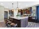 Gourmet kitchen boasts a large island, bar stools, pendant lighting, and stainless appliances at 1684 Beach St, Greenwood, IN 46143