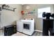 Bright laundry room with modern washer and dryer, shelving, and window for natural light at 1684 Beach St, Greenwood, IN 46143