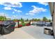 Covered outdoor patio with comfortable seating, a barbecue, and a view of the landscaped backyard at 1684 Beach St, Greenwood, IN 46143